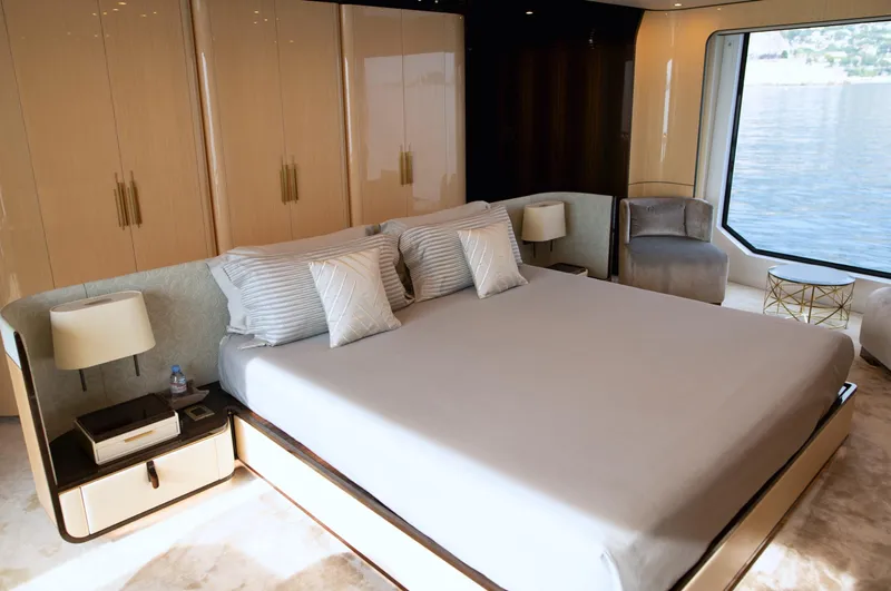 Sama Yacht Photos Pics Luxurious bedroom on 2017 Azimut Grande 35 Metri yacht with elegant decor and large window view.