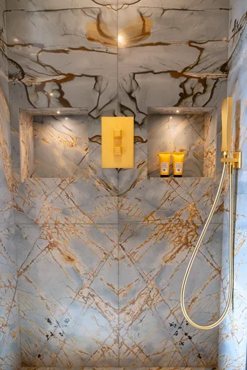 Sama Yacht Photos Pics Luxurious marble shower in 2017 Azimut Grande 35 Metri yacht, featuring gold fixtures and elegant design.