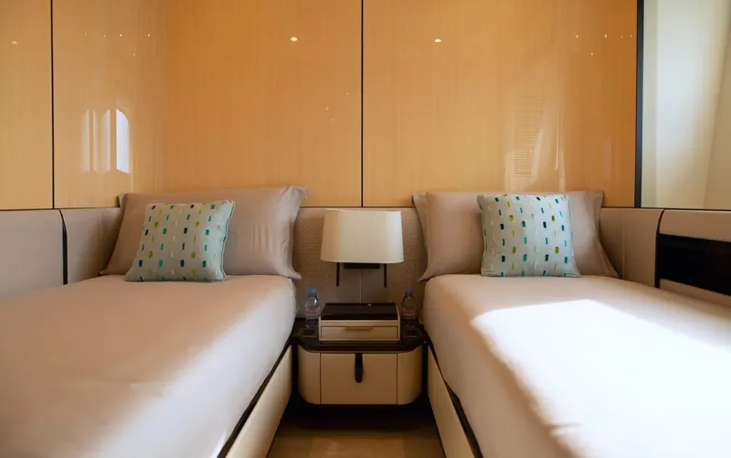 Sama Yacht Photos Pics Luxurious twin bedroom on 2017 Azimut Grande 35 Metri yacht, featuring elegant decor and modern amenities.