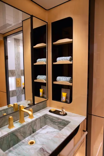 Sama Yacht Photos Pics Luxurious bathroom in 2017 Azimut Grande 35 Metri yacht with marble sink and gold fixtures.