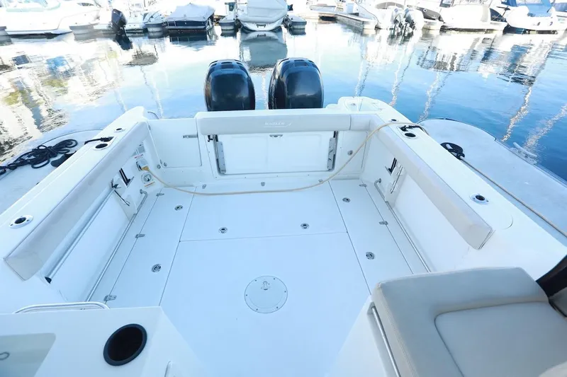 Libres Y Lokos Yacht Photos Pics 2016 Boston Whaler 285 Conquest boat deck with twin engines at marina.