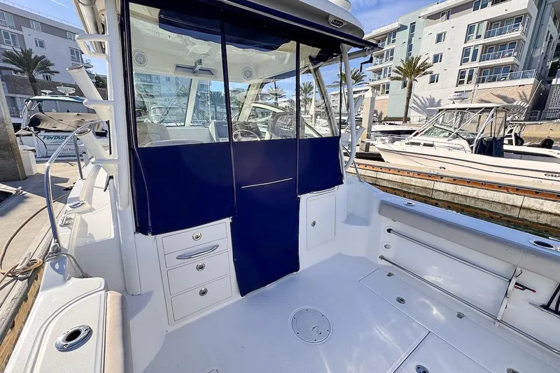 Libres Y Lokos Yacht Photos Pics 2016 Boston Whaler 285 Conquest boat interior at marina, featuring seating and storage.