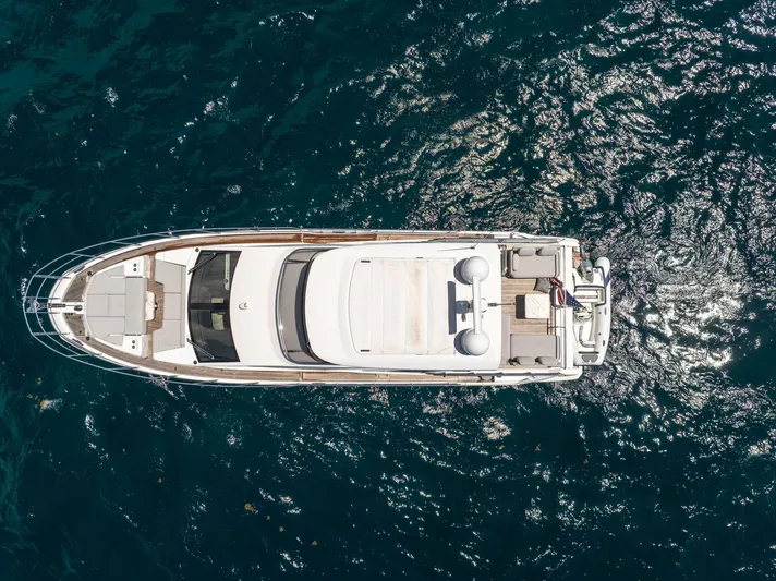  Yacht Photos Pics Aerial view of 2022 Azimut Fly 60 yacht on shimmering blue water.