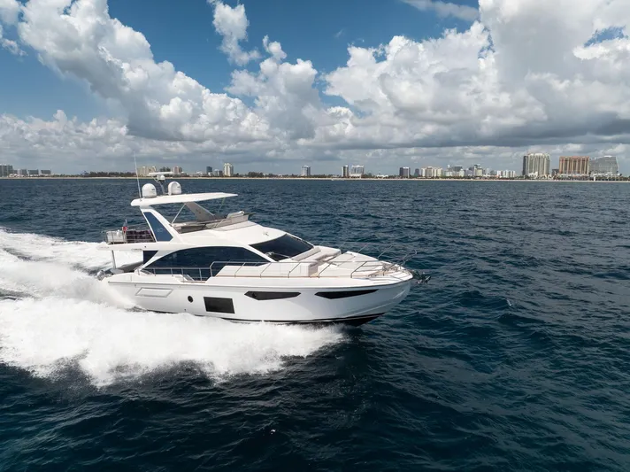  Yacht Photos Pics 2022 Azimut Fly 60 yacht cruising on open water under a partly cloudy sky.