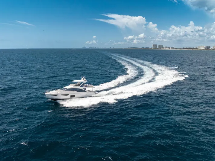  Yacht Photos Pics 2022 Azimut Fly 60 yacht cruising on open ocean under clear blue sky.