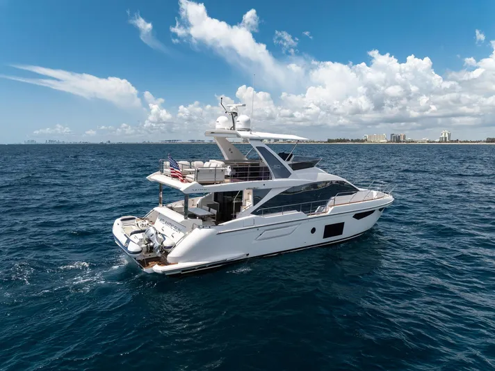  Yacht Photos Pics 2022 Azimut Fly 60 yacht cruising on open sea under blue sky.