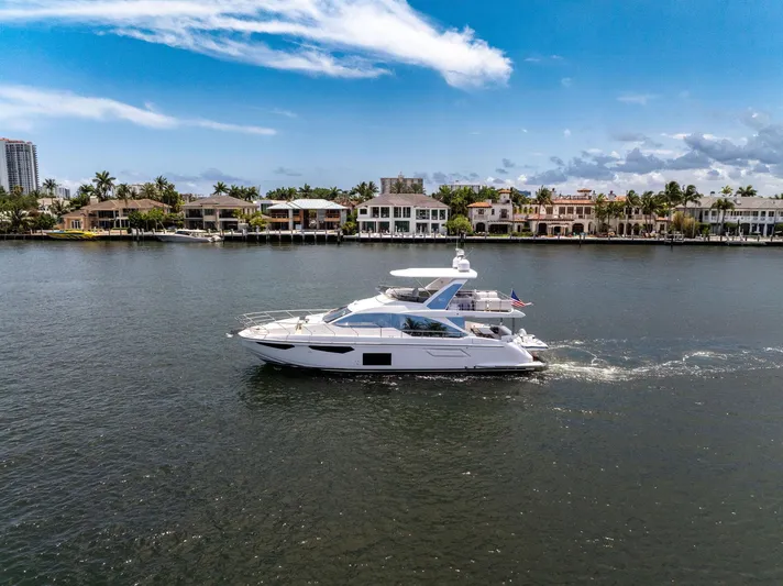  Yacht Photos Pics Azimut Fly 60 yacht cruising on a sunny day, 2022 model, near waterfront homes.