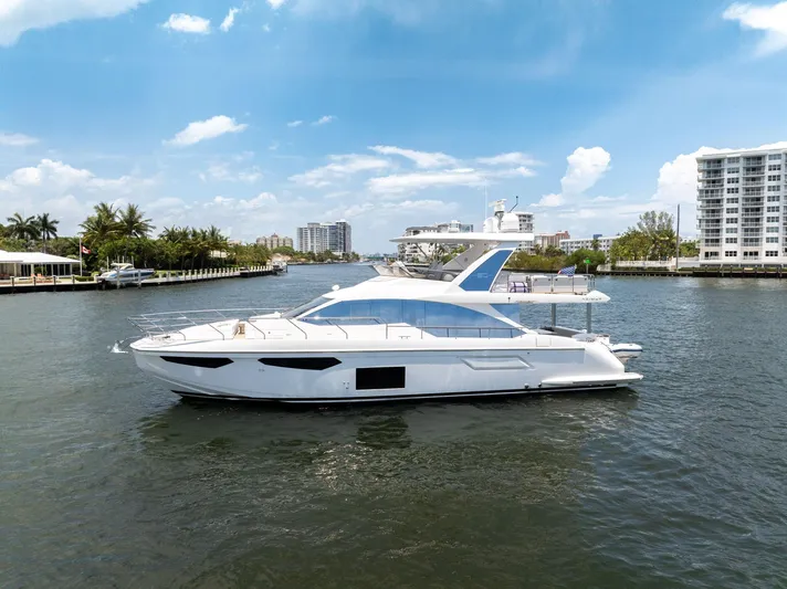  Yacht Photos Pics 2022 Azimut Fly 60 yacht cruising on a sunny day in a coastal waterway.