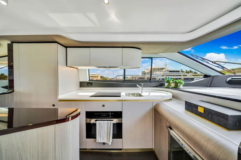  Yacht Photos Pics Modern kitchen interior of 2022 Azimut Fly 60 yacht with sleek design and panoramic windows.