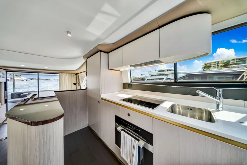  Yacht Photos Pics Modern kitchen interior of 2022 Azimut Fly 60 yacht with sleek design and waterfront view.