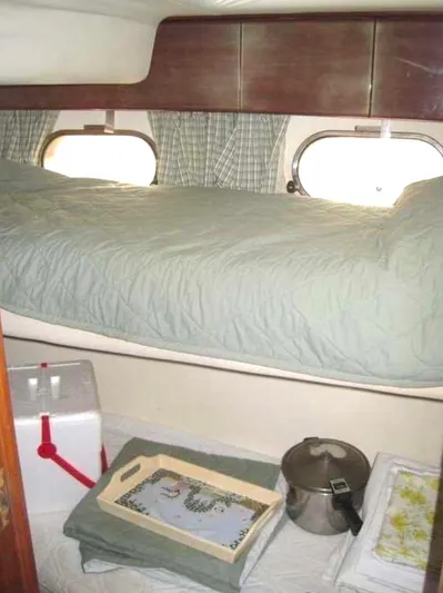  Yacht Photos Pics 1998 Viking Sports Cruiser cabin interior with bed, storage, and portholes.