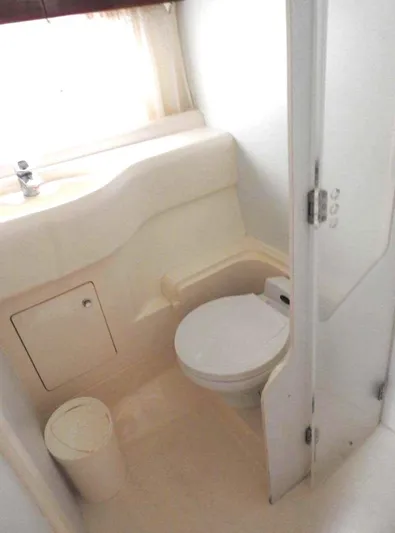  Yacht Photos Pics 1998 Viking Sports Cruiser bathroom interior with toilet and sink.