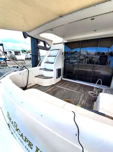  Yacht Photos Pics 1998 Viking Sports Cruiser yacht with spacious deck and elegant staircase.