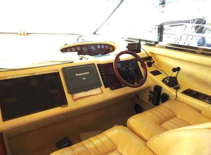  Yacht Photos Pics Interior of a 1998 Viking Sports Cruiser with steering wheel and navigation equipment.