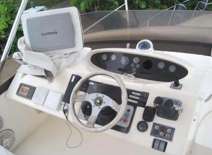  Yacht Photos Pics 1998 Viking Sports Cruiser dashboard with Garmin GPS, steering wheel, and control panel.