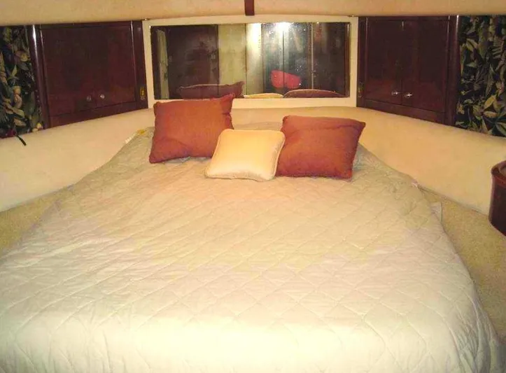  Yacht Photos Pics Cozy bedroom in 1998 Viking Sports Cruiser with pillows and quilted bedding.