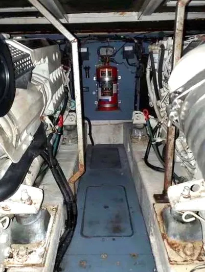  Yacht Photos Pics Engine room of a 1998 Viking Sports Cruiser with visible machinery and fire extinguisher.