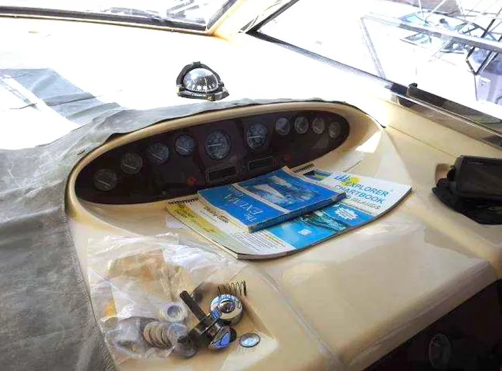  Yacht Photos Pics Control panel of a 1998 Viking Sports Cruiser with navigation charts and accessories.