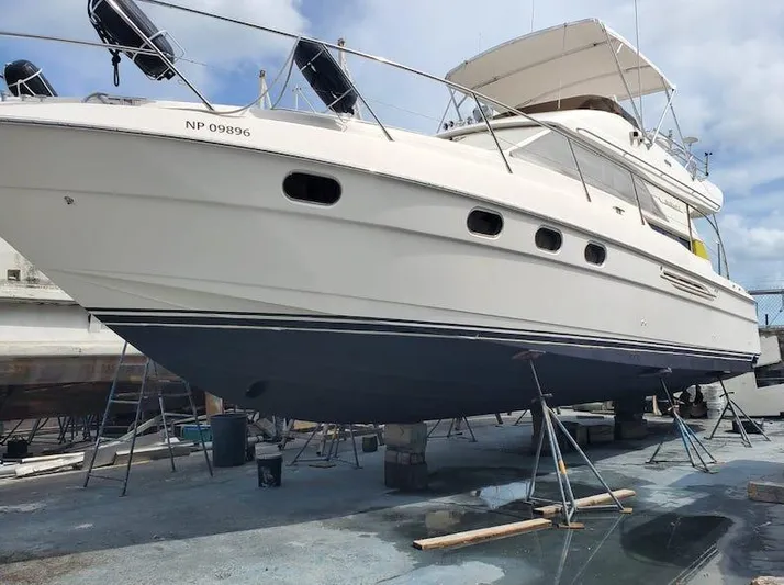  Yacht Photos Pics 1998 Viking Sports Cruiser yacht on dry dock for maintenance under a clear sky.