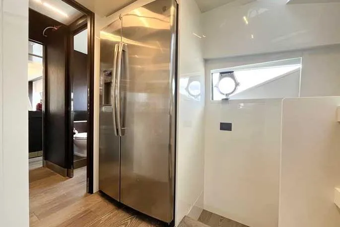  Yacht Photos Pics Modern kitchen area on a 2020 Ferretti Yachts 850, featuring a stainless steel refrigerator.