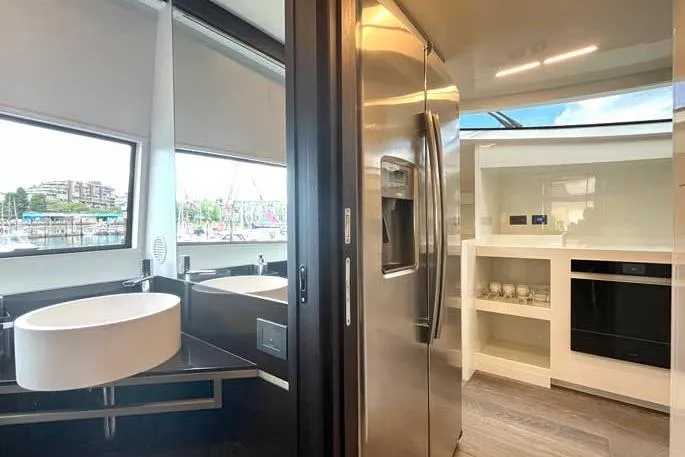 Yacht Photos Pics Modern kitchen and bathroom interior on 2020 Ferretti Yachts 850, featuring sleek appliances and fixtures.