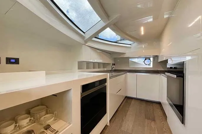  Yacht Photos Pics Modern kitchen interior on 2020 Ferretti Yachts 850, featuring sleek design and ample natural light.