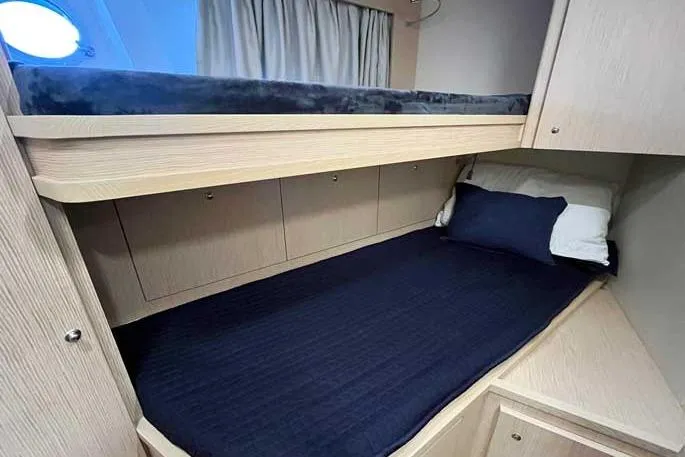  Yacht Photos Pics 2020 Ferretti Yachts 850 cabin with bunk beds and navy bedding.