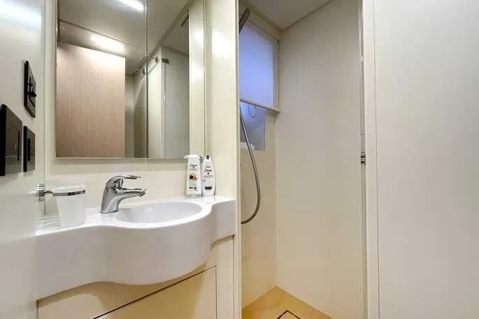  Yacht Photos Pics Modern bathroom interior on 2020 Ferretti Yachts 850, featuring sleek sink and shower area.