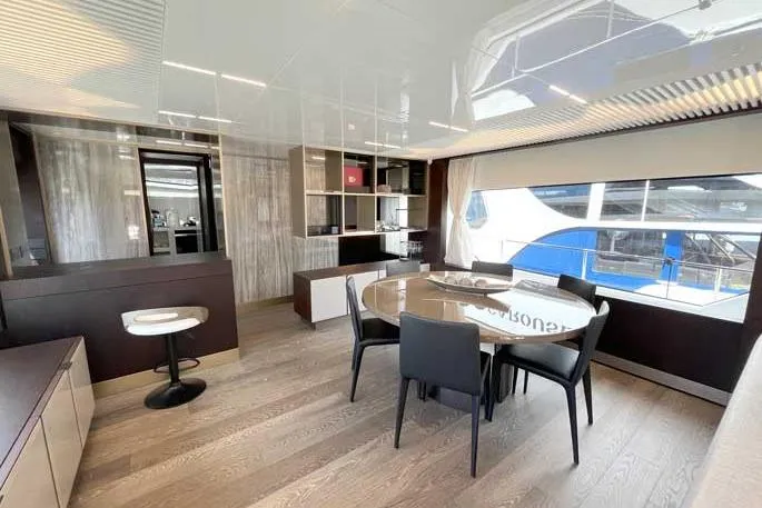  Yacht Photos Pics Luxurious interior of 2020 Ferretti Yachts 850 with modern dining area and large window view.