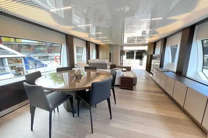  Yacht Photos Pics Luxurious interior of 2020 Ferretti Yachts 850 with modern dining area and panoramic windows.