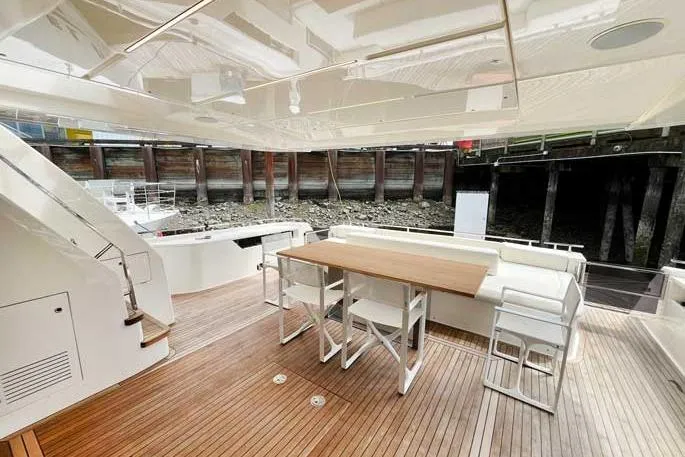  Yacht Photos Pics Luxurious 2020 Ferretti Yachts 850 deck with elegant seating and wooden flooring.