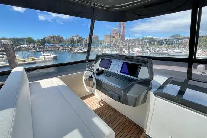  Yacht Photos Pics Helm of 2020 Ferretti Yachts 850 with marina view, featuring modern navigation equipment.
