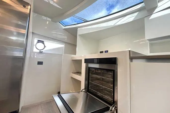  Yacht Photos Pics Modern kitchen interior on 2020 Ferretti Yachts 850 with skylight and stainless steel appliances.