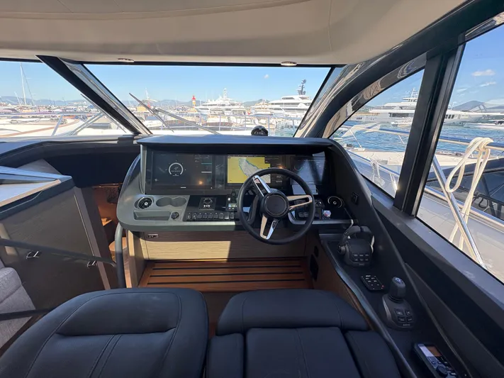  Yacht Photos Pics Helm of 2025 Princess V55 yacht with modern controls and panoramic view.