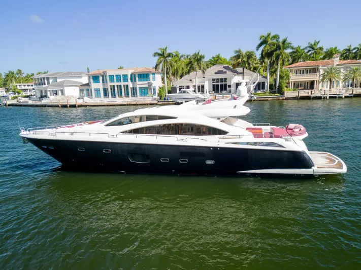  Yacht Photos Pics Luxurious 2013 Sunseeker Predator 84 yacht cruising near waterfront homes.