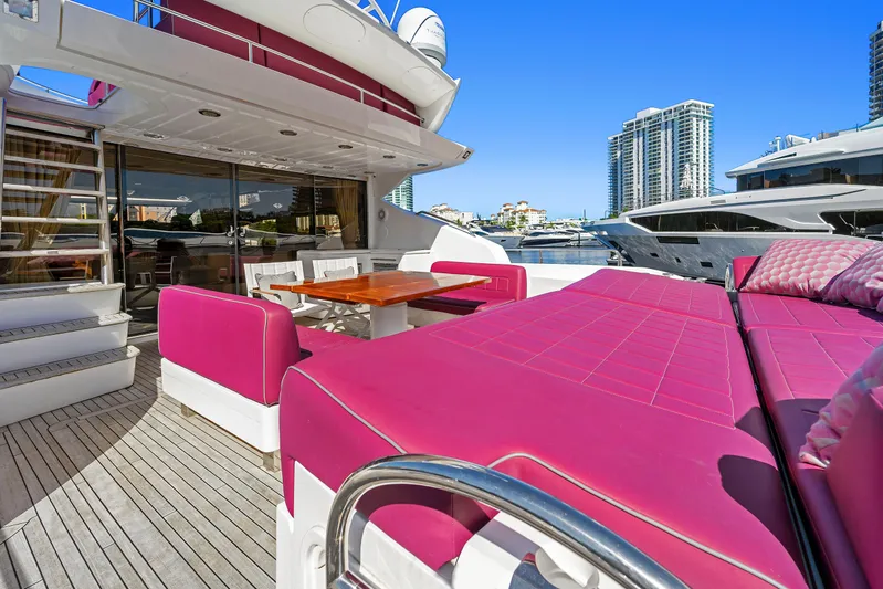  Yacht Photos Pics Luxurious Sunseeker Predator 84 yacht with vibrant pink seating, docked in a marina.