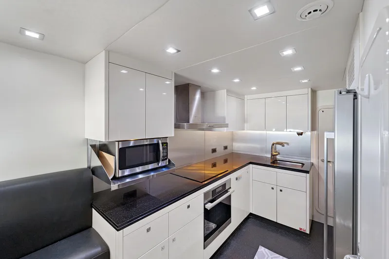  Yacht Photos Pics Modern kitchen interior on 2013 Sunseeker Predator 84 yacht, featuring sleek cabinetry and appliances.