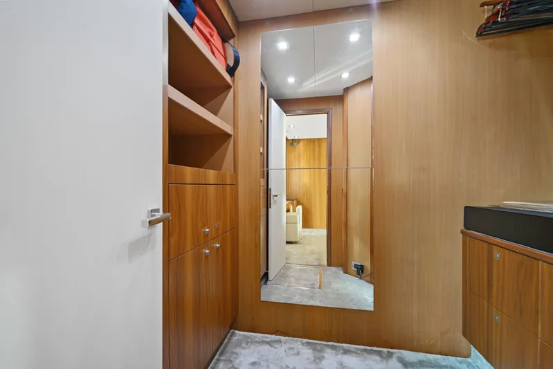  Yacht Photos Pics Luxurious interior of 2013 Sunseeker Predator 84 yacht with wooden cabinetry and mirrored wall.