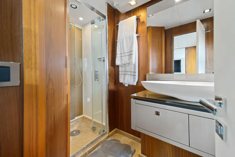  Yacht Photos Pics Luxurious bathroom in 2013 Sunseeker Predator 84 yacht with modern shower and wooden accents.