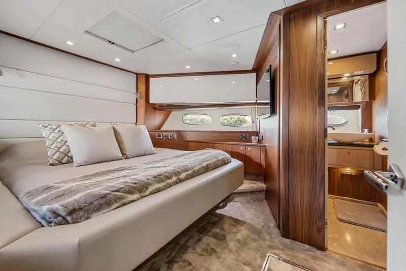  Yacht Photos Pics Luxurious bedroom interior of 2013 Sunseeker Predator 84 yacht with elegant wood finishes.