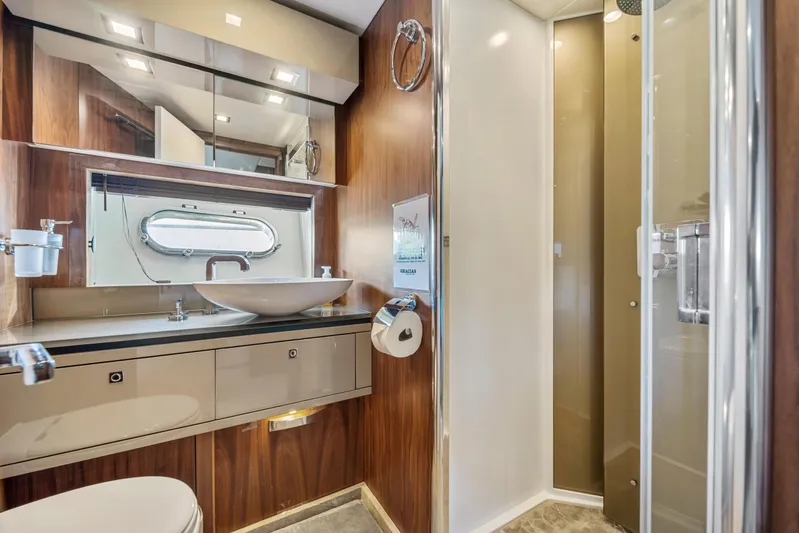  Yacht Photos Pics Luxurious bathroom in 2013 Sunseeker Predator 84 yacht with modern fixtures and wood accents.