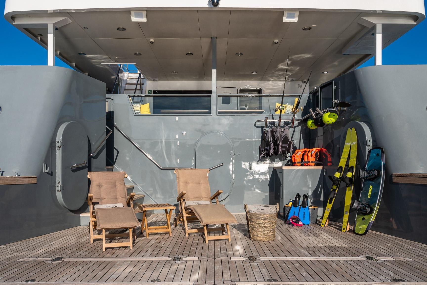 Deck of 2005 Tenix Defence ICE Explorer yacht with chairs and water sports gear.