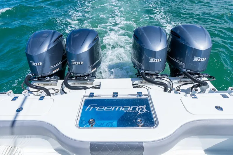  Yacht Photos Pics Four powerful outboard motors on a 2018 Freeman 37 VH boat cruising through blue waters.