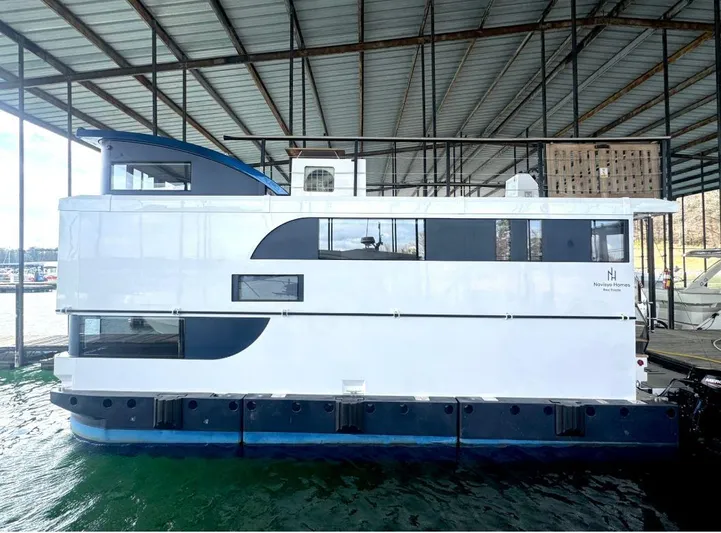  Yacht Photos Pics Modern 2022 Navisyo Homes NV.08 houseboat docked under a covered marina.
