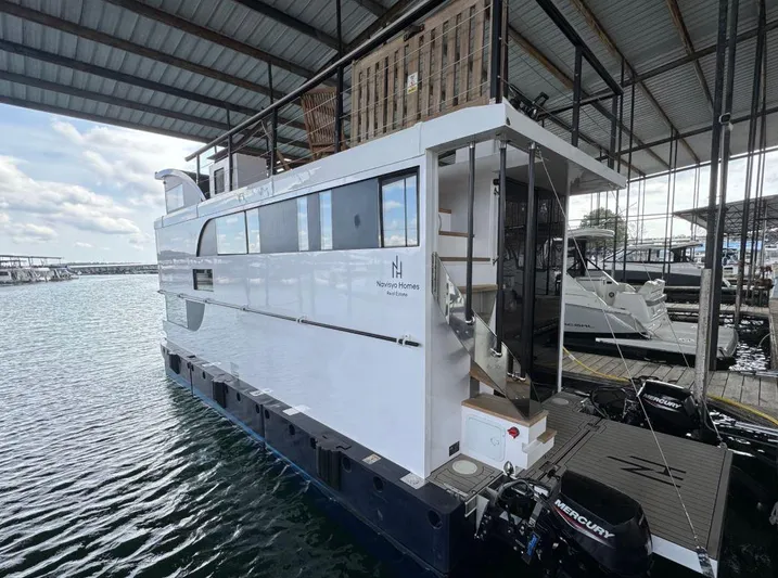  Yacht Photos Pics Modern 2022 Navisyo Homes NV.08 houseboat docked in a marina under a covered structure.