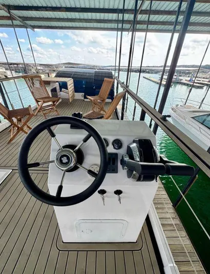  Yacht Photos Pics Steering console on Navisyo Homes NV.08 houseboat, 2022 model, with deck chairs and marina view.