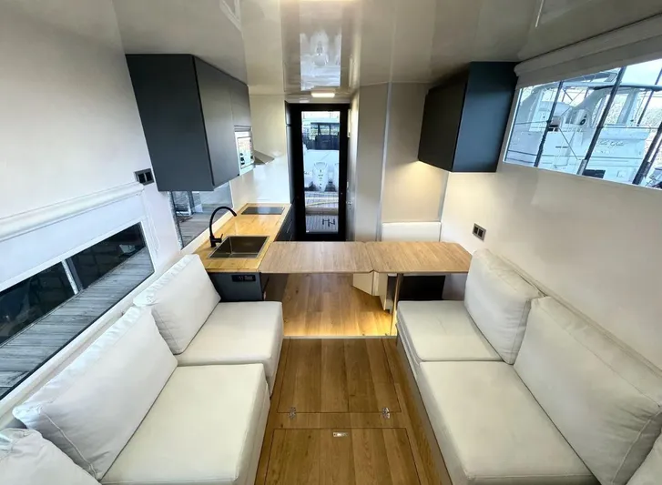  Yacht Photos Pics Modern Navisyo Homes NV.08 interior with sleek kitchen, white sofas, and wooden flooring, 2022 model.