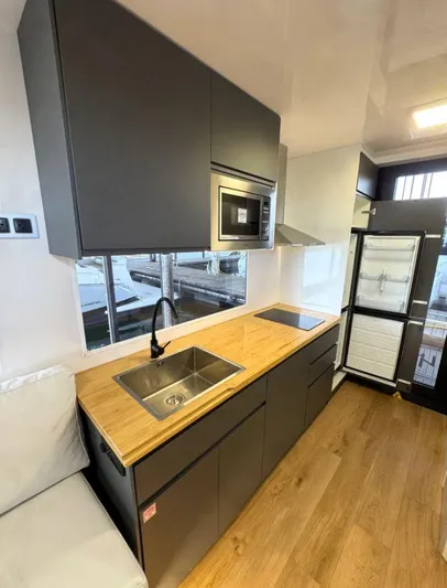  Yacht Photos Pics Modern kitchen in 2022 Navisyo Homes NV.08 with wood countertops and sleek appliances.