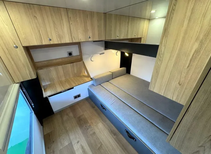  Yacht Photos Pics Modern Navisyo Homes NV.08 interior with wooden cabinets, foldable desk, and gray seating, 2022 model.