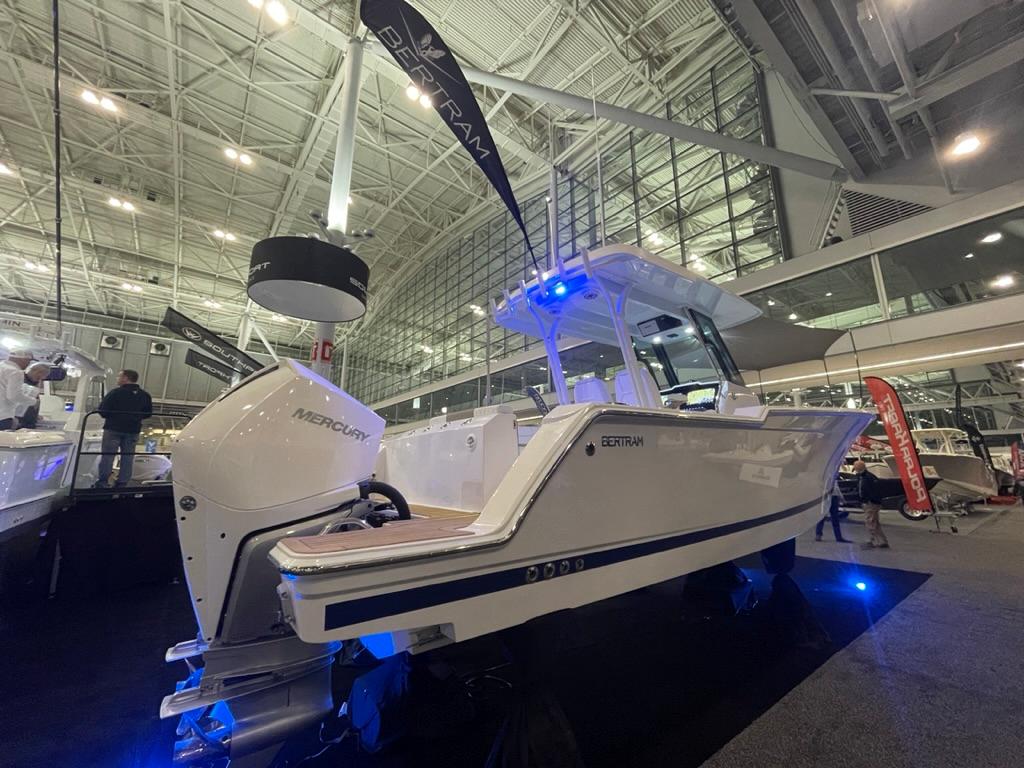 2023 Bertram 28 CC boat on display at an indoor boat show.